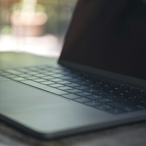 Closeup image of computer laptop on wooden table in cafe